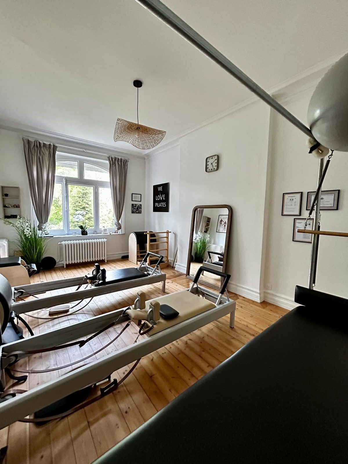 L'espace Machines du studio Move and Breathe : Reformers alignés devant la fenêtre, miroir et affiche We Love Pilates